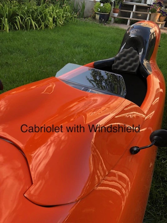 A bright orange velomobile with a 