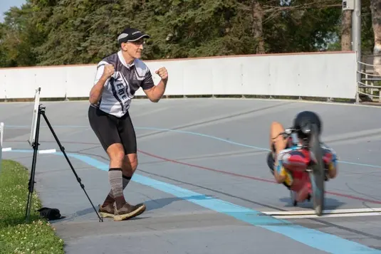 Recumbent bicycle racer speeding past the coach