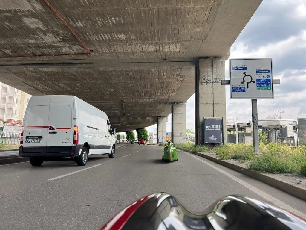View from a red velomobile in Turin street