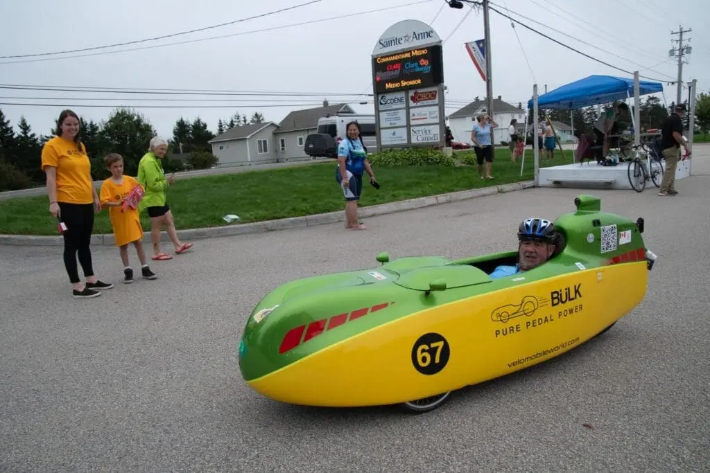 John Trites in his yellow-green bülk velomobile