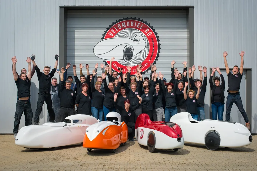 The velomobile world team in front of the factory